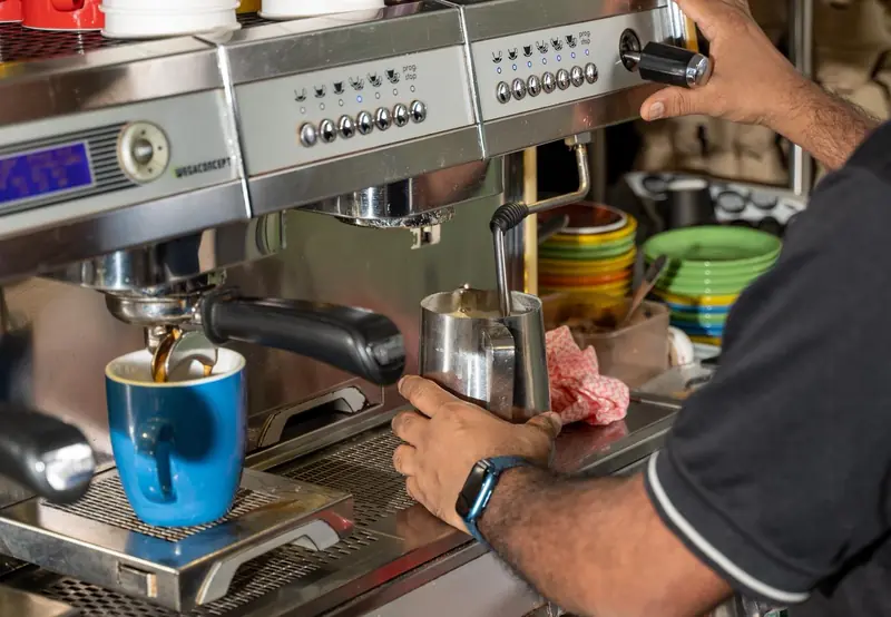 Barista crafting coffee at MK Bower